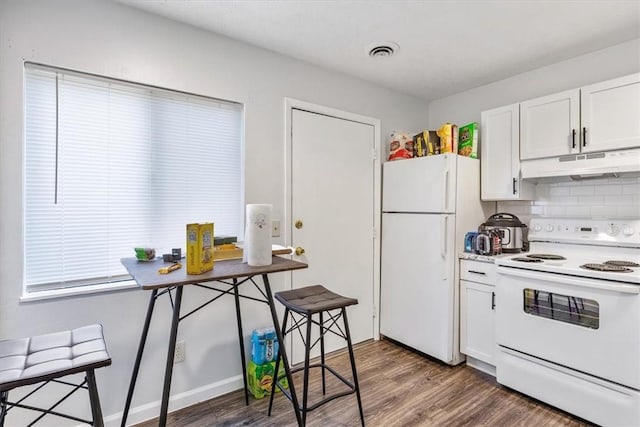 kitchen with backsplash, white appliances, dark wood-type flooring, and white cabinets