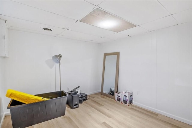 miscellaneous room with light hardwood / wood-style flooring and a paneled ceiling