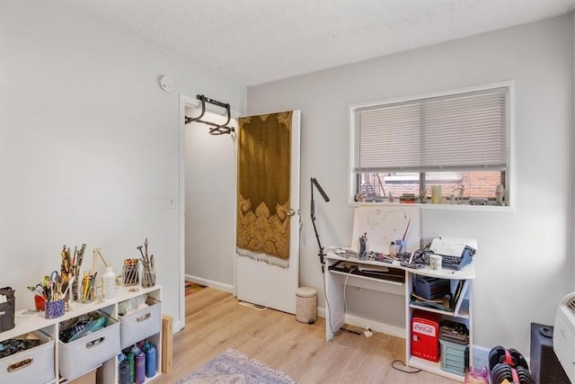 interior space with a textured ceiling and light hardwood / wood-style floors