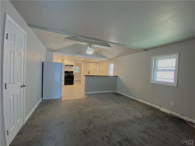 interior space with carpet, vaulted ceiling with beams, a wealth of natural light, and ceiling fan