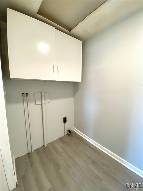 washroom featuring light hardwood / wood-style flooring and cabinets