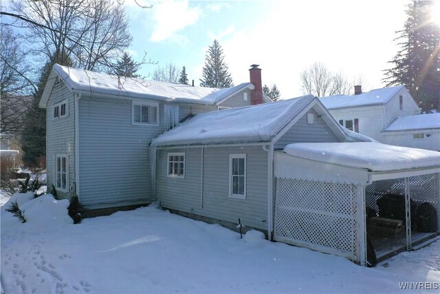 view of snow covered rear of property