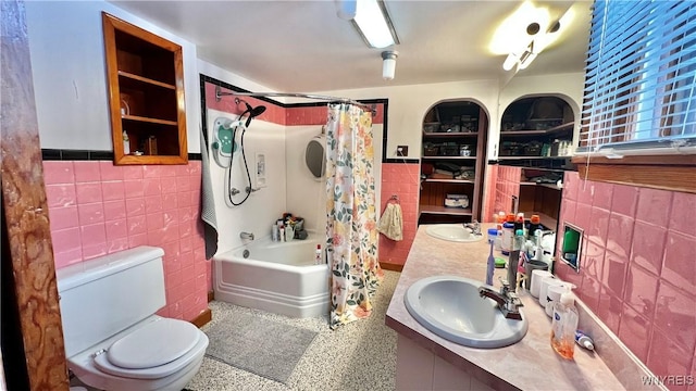 full bathroom with shower / bath combo, tile walls, vanity, and toilet