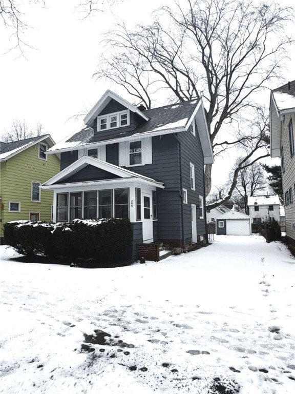 snow covered house with a garage