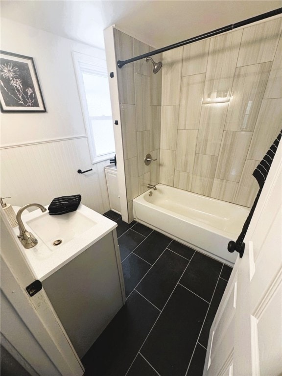 bathroom featuring tiled shower / bath combo, vanity, and tile patterned flooring