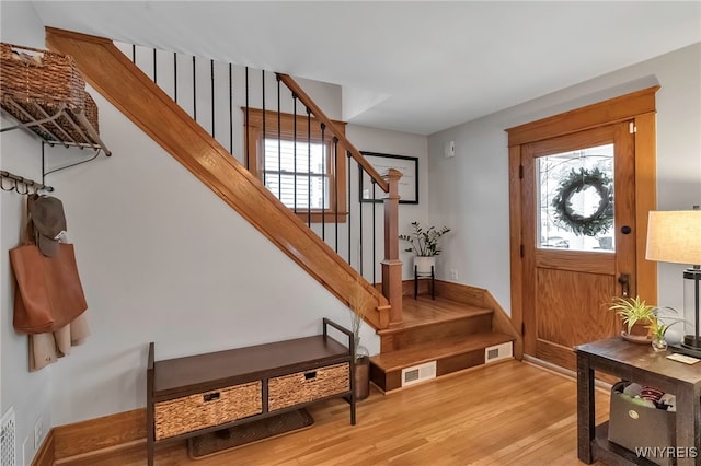 foyer with a healthy amount of sunlight and light hardwood / wood-style flooring