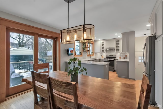 dining room featuring sink and light wood-type flooring