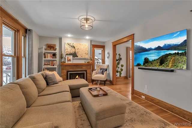 living room with light hardwood / wood-style flooring and a fireplace