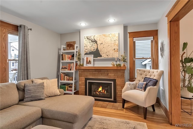 sitting room featuring a fireplace and light hardwood / wood-style floors