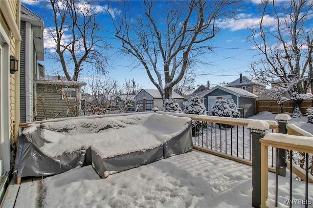 snow covered deck featuring a storage unit