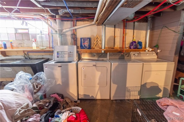 laundry room with separate washer and dryer and sink