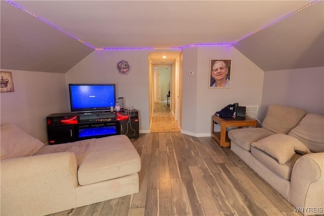 living room with lofted ceiling and hardwood / wood-style flooring