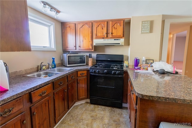 kitchen with sink, kitchen peninsula, track lighting, and black range with gas cooktop