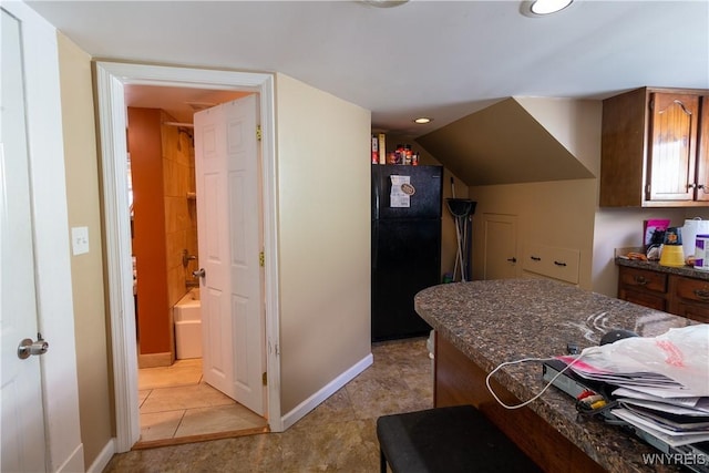 kitchen featuring black refrigerator