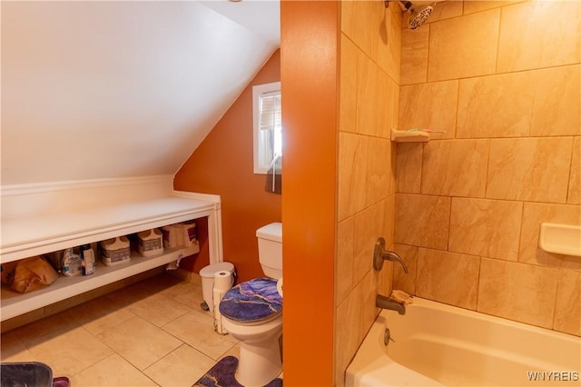 bathroom with tiled shower / bath, lofted ceiling, and toilet