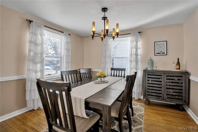 dining space featuring a chandelier and light hardwood / wood-style floors