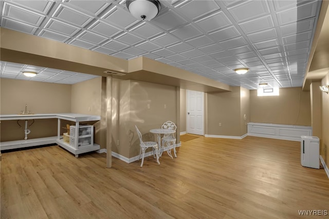 basement with hardwood / wood-style flooring