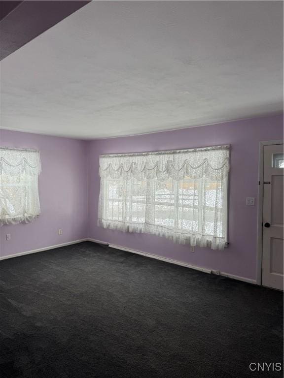 empty room featuring dark colored carpet