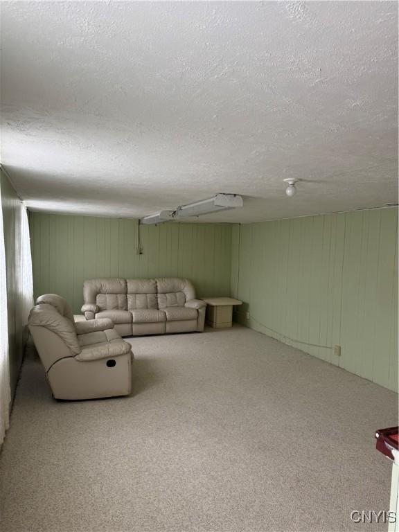 carpeted living room with a textured ceiling