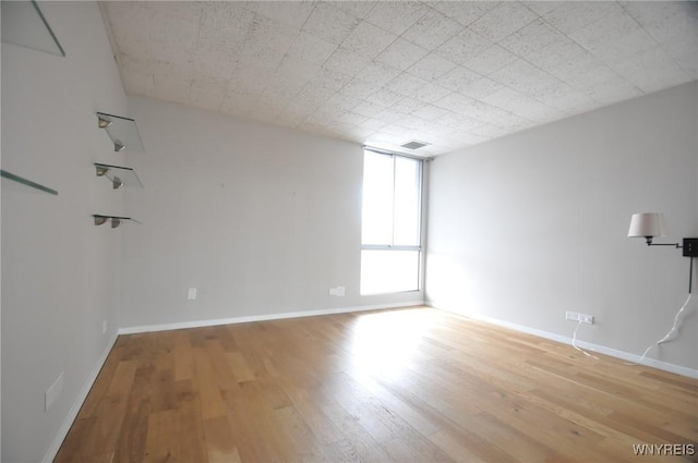 spare room featuring light hardwood / wood-style flooring