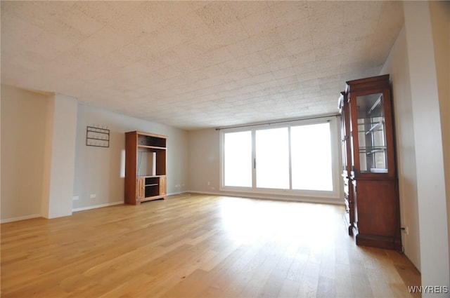 unfurnished living room with light wood-type flooring