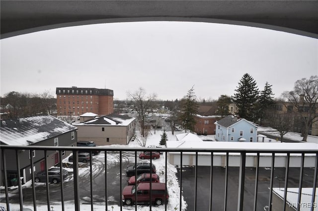 view of snow covered back of property