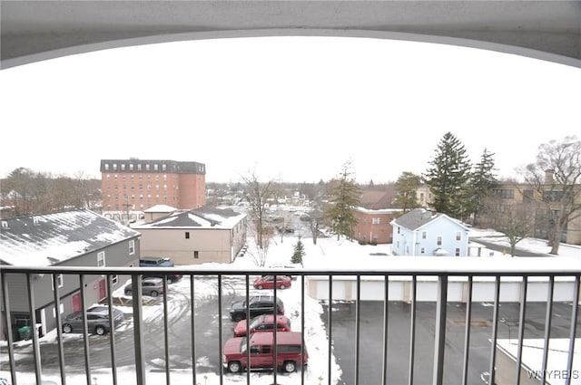 view of snow covered back of property