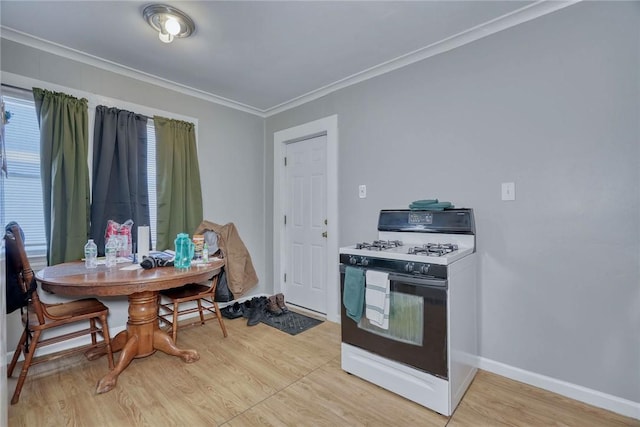 kitchen with white range with gas cooktop, crown molding, and light wood-type flooring