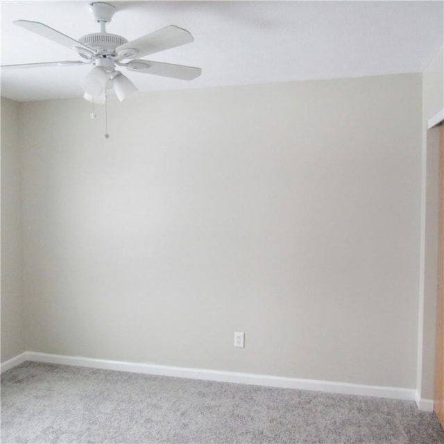 unfurnished room with baseboards, ceiling fan, and light colored carpet