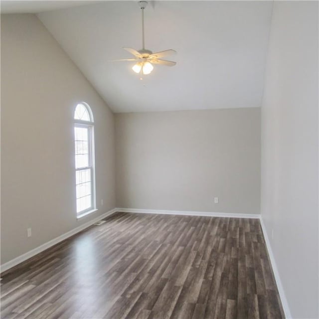 interior space featuring lofted ceiling, baseboards, dark wood finished floors, and a ceiling fan