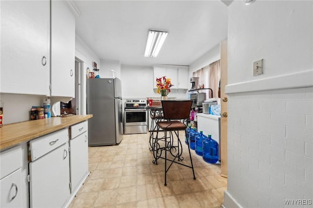 kitchen featuring appliances with stainless steel finishes and white cabinets