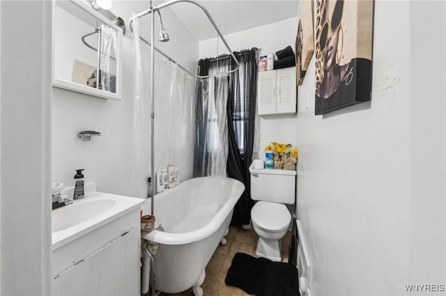 full bathroom with vanity, shower / tub combo with curtain, and toilet