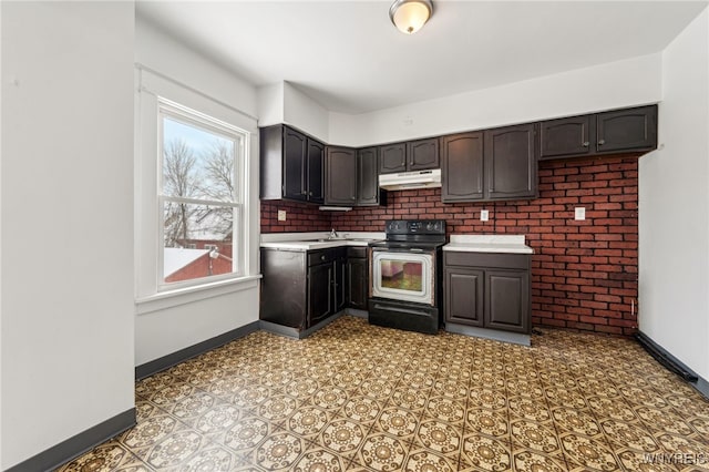 kitchen featuring electric range oven, backsplash, and dark brown cabinetry