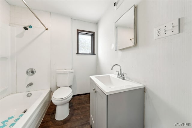 full bathroom featuring vanity, hardwood / wood-style floors, bathtub / shower combination, and toilet