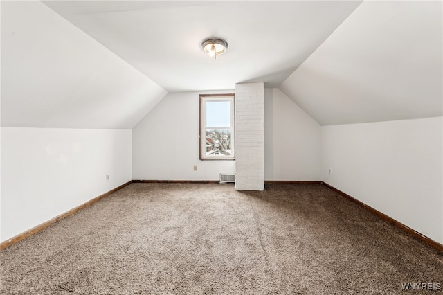 additional living space featuring lofted ceiling and carpet