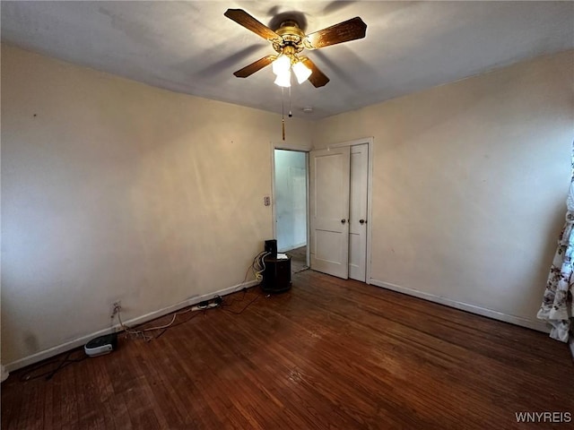 unfurnished bedroom featuring dark wood-type flooring, ceiling fan, and a closet