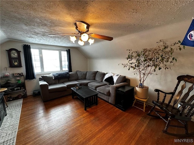 living room with dark hardwood / wood-style flooring, vaulted ceiling, and a textured ceiling