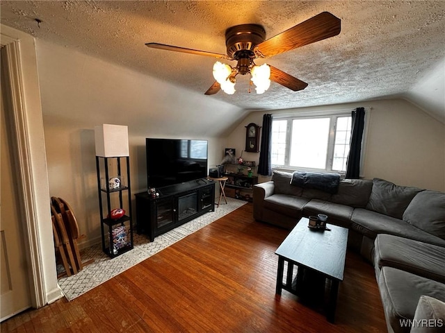 living room featuring hardwood / wood-style flooring, lofted ceiling, and a textured ceiling