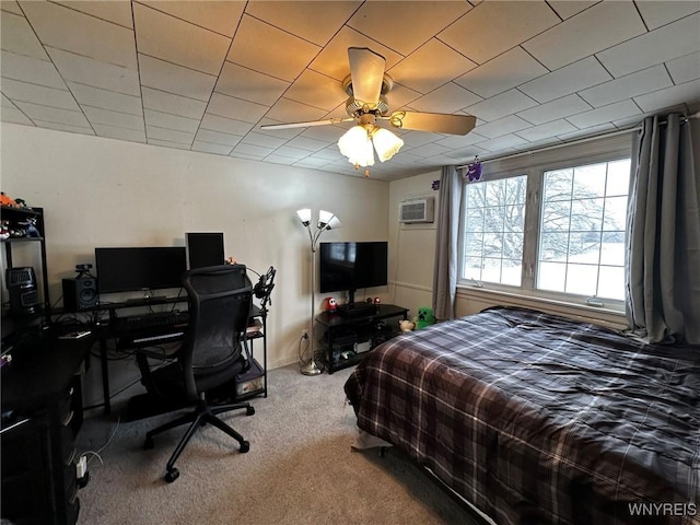 carpeted bedroom with an AC wall unit and ceiling fan