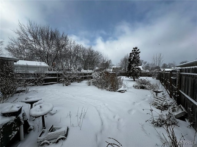 view of yard layered in snow