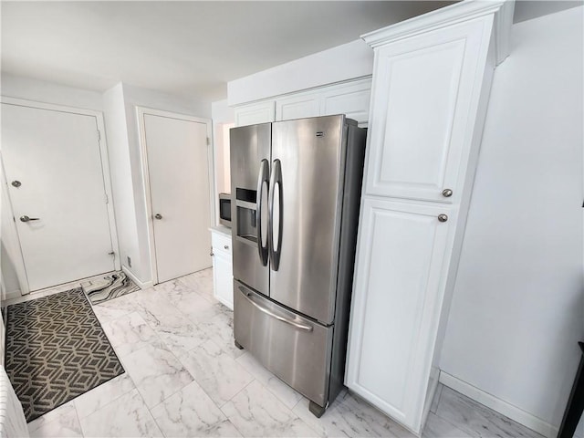 kitchen featuring stainless steel appliances and white cabinets