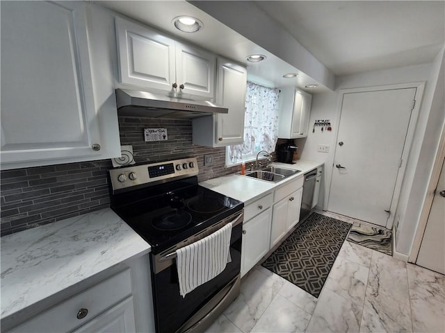 kitchen with white cabinetry, appliances with stainless steel finishes, sink, and decorative backsplash