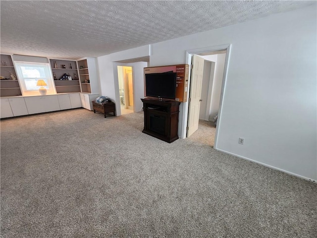 unfurnished living room featuring carpet floors and a textured ceiling