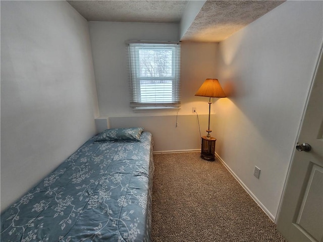 bedroom featuring carpet and a textured ceiling