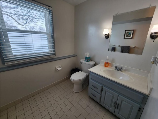 bathroom with vanity, tile patterned floors, and toilet