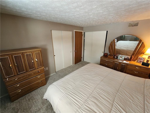 carpeted bedroom with a textured ceiling