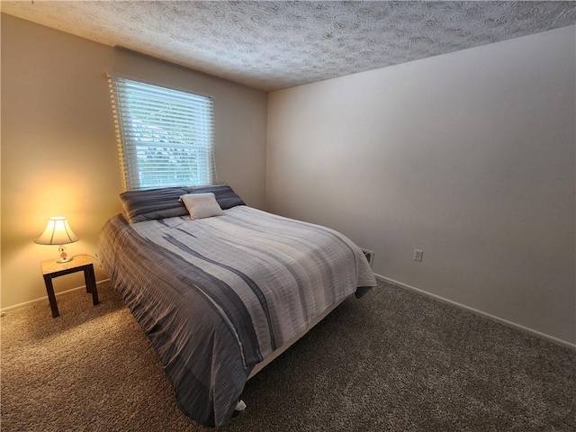 carpeted bedroom featuring a textured ceiling