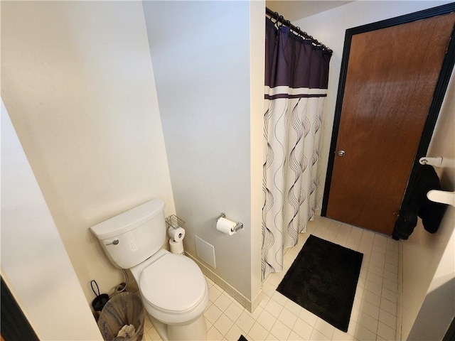 bathroom with toilet and a shower with shower curtain