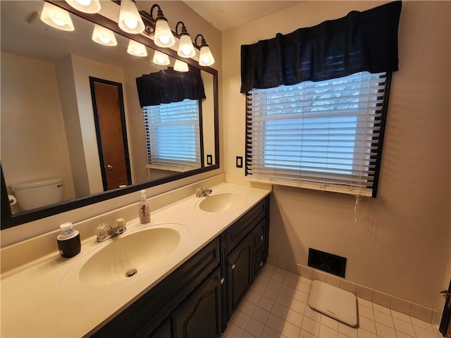 bathroom with tile patterned floors, vanity, and toilet