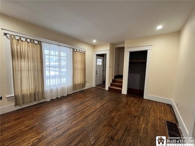 unfurnished bedroom featuring dark hardwood / wood-style flooring